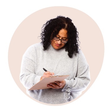 A person writing on a form.